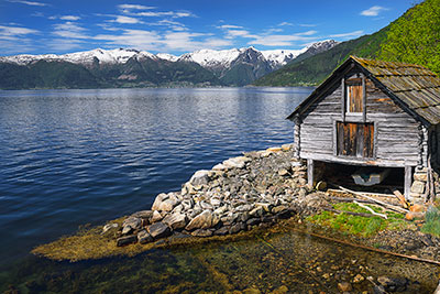 Norwegen, Vestland, Vestland,Sognefjord, Holzhütte am Sognefjord mit Gletscher Bjornabreen und Langedalsbreen im Hintergrund